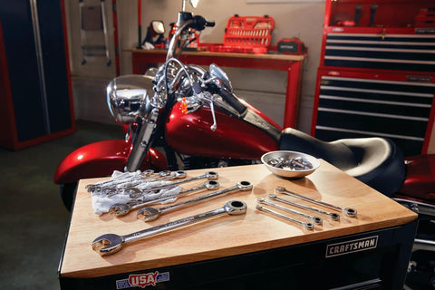 11 Piece SAE Ratcheting Wrench Set with 72 Tooth Box End, chrome finish, on workbench with motorcycle in garage setting.