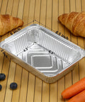 60 Pack Aluminum Foil Pans With Lids, 8.5 By 6 Inch, 2.25 Lb Capacity, displayed with croissants and carrots on a wooden surface