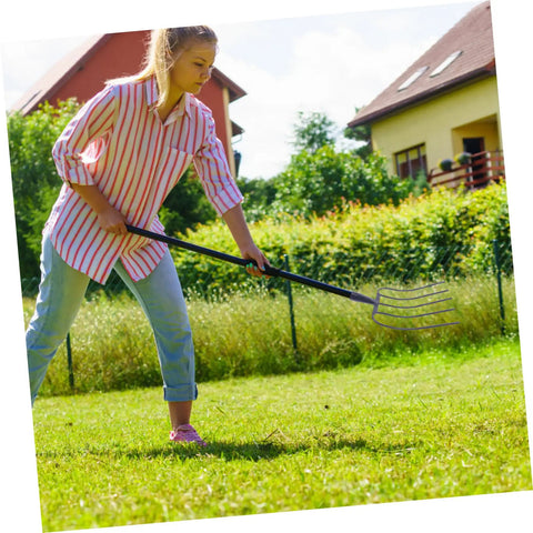 Woman using Handheld Manure Fork Multi Functional Farm Tool For Easy Lawn Maintenance And Manure Clearing With Iron Construction