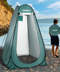 Extra Tall Pop Up Privacy Shower Tent for Camping and Beach in Army Green on sandy beach near water