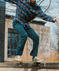 Skateboarder performing a trick using 4 Pack 52mm Skateboard Wheels With Bearings 95A Hardness Durable Street Trick Wheels.