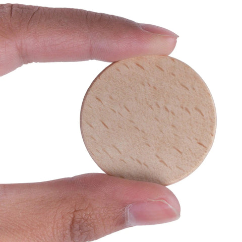 Premium Unfinished Wood Cutout Circles 1.5 Inches held in hand, showing smooth surface for DIY projects and crafts.