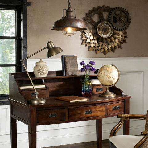 Antique office desk with vintage decor, globe, and industrial lamp, featuring gear wall art and dark wood finish.