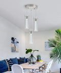 Modern dining room with Three Light Bubble Cylinder LED Pendant Light in Brushed Nickel With Adjustable Length above table.