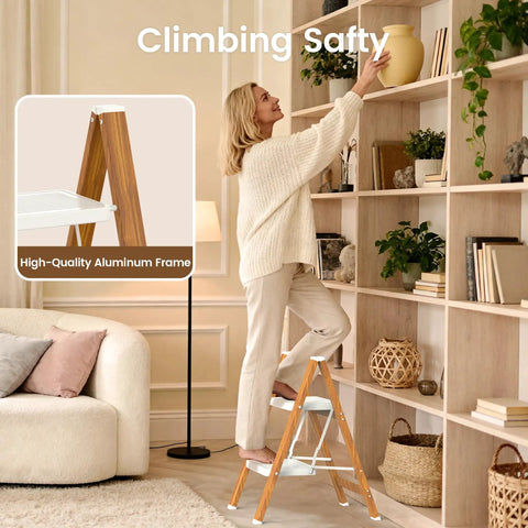 Lightweight Aluminum 2 Step Folding Ladder With Wide Pedals And Anti Slip Grip For Safer Heights Opens To 18 x 20.8 x 24 Inches Folds Down To 25.9 x 18 x 1.9 Inches And Weighs Just 5.73 Pounds For Easy Indoor Or Outdoor Use. woman using 2-step folding ladder to reach shelf