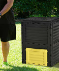 80 Gallon Garden Compost Tumbler Bin With Dual Side Loading Yellow Unit 23.75 By 23.75 By 32 Inch Size on grass