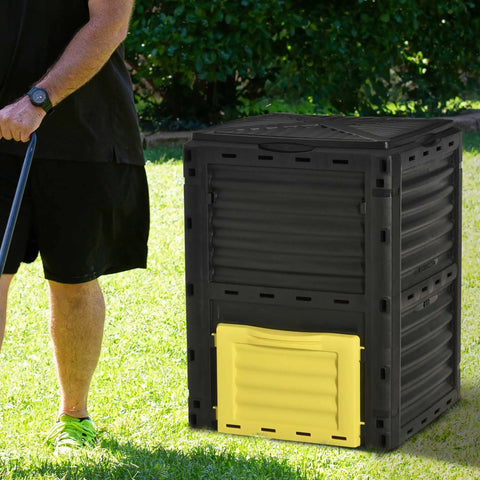 80 Gallon Garden Compost Tumbler Bin With Dual Side Loading Yellow Unit 23.75 By 23.75 By 32 Inch Size on grass