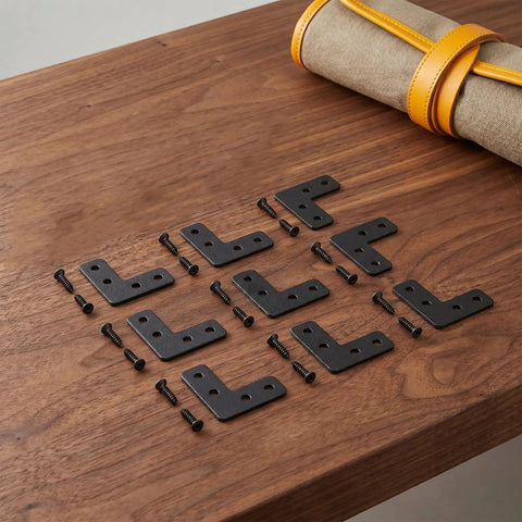 20 Pack Black Stainless Steel Corner Brackets With Enhanced 90 Degree Design For Wall Mounts Flat Right Angle Braces arranged on table