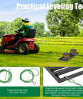 Beast Pro Grade Lawn Leveling Rake With 70.5 Inch Adjustable Handle And 34.1 By 9.4 Inch Head, attached to a tractor on grass