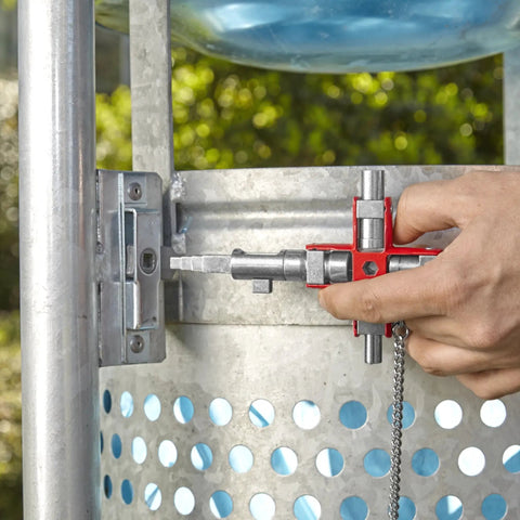 Universal Construction Control Cabinet Key with Plug In Magnetic Support unlocking an industrial cabinet, close-up view.