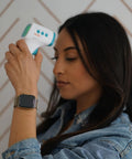 No Contact Forehead Thermometer For Baby Kids And Adults, 1 Second Infrared Temperature Readings, Fever Indicator With Color Coded Readings, Silent Mode, Touchless With Object Temperature And Room Temperature Modes; woman using white thermometer
