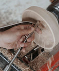 Woodturning tool with 1-inch stem used on a spinning wooden bowl on a lathe