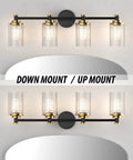 Black and Brass Vanity Light Fixture with Cylindrical Clear Stripes Glass Shade and Four Light E26 Socket Base Over Mirror