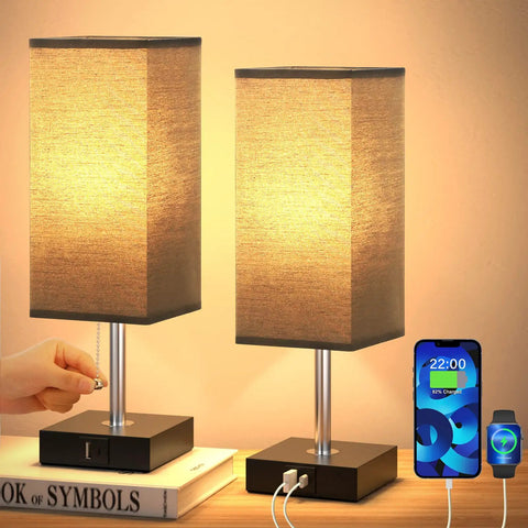 Set Of 2 Bedside Lamps With Dual USB Ports, Small Nightstand Table Lamps With Black Fabric Shade For End Tables shown lit on books
