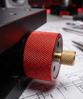 Close-up of heavy duty manual pivot angle platform knob, featuring red anodized aluminum for precise adjustments.