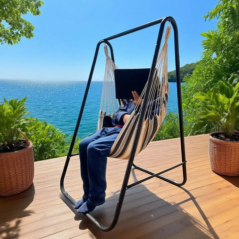 Weatherproof Hammock Chair Stand With Hanging Swing Chair Included, Rugged Iron Frame Supports Up To 450 Lbs on a patio by the sea