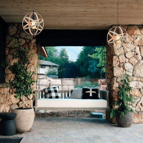 Outdoor scene featuring Industrial Spherical Pendant Light With Changeable Cage Design, hanging under rustic stone arch.