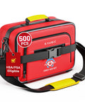 KAUGIC red first aid kit bag with 500 PCS label, yellow top handle, black adjustable strap front view