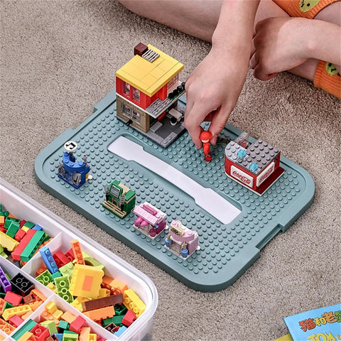 Child organizing Lego figures on Slick 3 Tier Stackable Brick Storage Organizer With Removable Grid Trays For Lego Pieces.