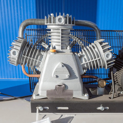 Close-up of a Built Tough Cast Iron Air Compressor with four-way manifold block, showing detailed machined inner threads and ports.