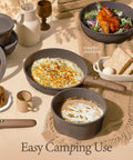 Camping scene with 27 Piece Nonstick Pots And Pans Set With Detachable Handle, pasta and chicken dishes displayed.