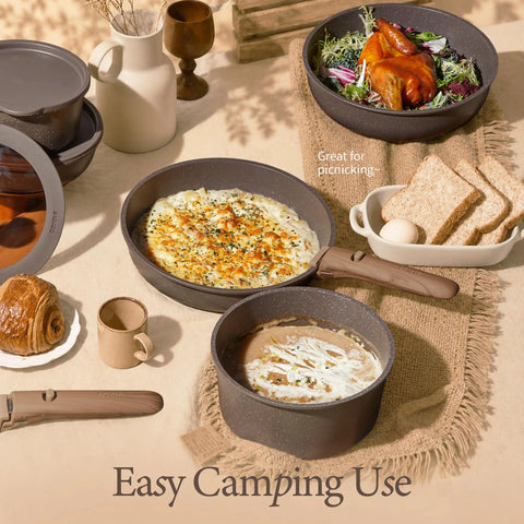 Camping scene with 27 Piece Nonstick Pots And Pans Set With Detachable Handle, pasta and chicken dishes displayed.