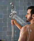 Person using Quattro Handheld Shower System With Four Modes Relieve Soothe Clarify Cleanse Magnetix Dock Chrome Finish