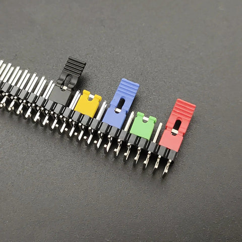 Assorted colored jumper caps on circuit board header, part of 200Pcs Mixed Jumper Caps Kit 2.54mm Pitch For Arduino Raspberry Pi PCB Projects