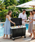 People enjoying drinks by a poolside with a 100 Quart Outdoor Cooler With Divider For Parties, Patio Ice Chest On Wheels.