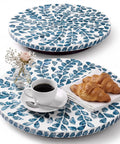Two Pack Mother Of Pearl Lazy Susan Turntable Set With Blue Wicker 12 And 13 Inch Rotating Trays on a table with coffee and croissants.