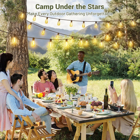 People enjoying a meal under 200Ft Solar String Lights Outdoor Waterproof With 72 LED Bulbs Plus 2 Spares, Remote And USB Port, 3 Light Modes, Dimmable Patio Lights For Large Backyard, Garden, Parties And Outdoor Gatherings, with a guitarist playing music.