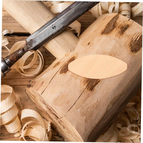 Premium 100 Pack Woodworking Biscuits For Slotting Machines Furniture Framing Connectors on wood with shavings.