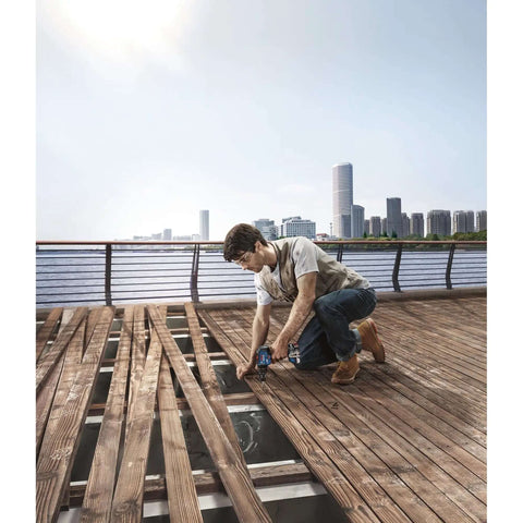 18V System Bad Boy Cordless Combi Drill With 55 Nm Kickin Torque Brushless Motor For Impact Drilling And Screwdriving Up To 35 Mm With Solid Metal Gearing Heavy Duty Workhorse Tool Body Only Included used by worker assembling wooden floor.