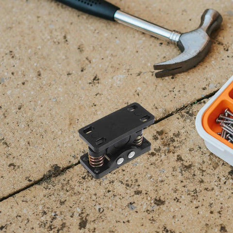 Heavy Duty Zinc Alloy Double Roller Door Latch With Ball Catch, Black Spring Loaded Clamp on workshop surface with tools