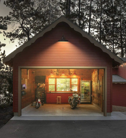Gooseneck Barn Light With Dusk To Dawn Sensor Outdoor Wall Sconce illuminating a red garage exterior at dusk with a motorcycle inside