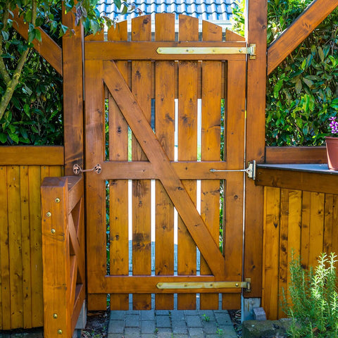 Wooden garden gate with brown finish shown with a Two Pack 2 Inch Hook And Eye Latch For Privacy Stainless Steel Barn Door Lock Hardware