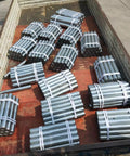 Built Tough 2 Inch Stainless Steel Conveyor Rollers 5 Pack For Zero Hassle Material Moving And Easy DIY Dock Trailer Setups Corrosion Resistant Heavy Duty Shafts stacked neatly in a shipping container.
