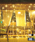Outdoor 304 LED Curtain Lights 9.8Ft By 9.8Ft with 8 Modes displayed on patio with warm white glow, plug-in shown