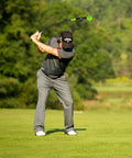 Golfer using Lag Trainer For Golf Swing Practice And Warmup, Tempo Drill To Build Consistency on a green fairway