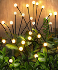 Solar Outdoor Firefly Lights For Garden And Yard Waterproof Wind Swaying Pathway Stakes with glowing bulbs among leaves