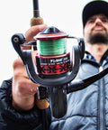 Man holding Lightweight Flame Spinning Reel With Ultra Smooth 9 Plus 1BB Technology Carbon Fiber Frame 19.8 Lb Max Drag 1000 Series