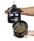 Person holding Quarter Acre Mosquito And Flying Insect Trap With UV Light Diffuser and TiO2 Coating Lure.