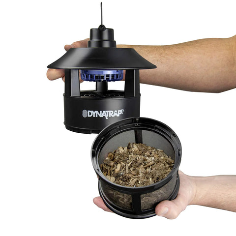 Person holding Quarter Acre Mosquito And Flying Insect Trap With UV Light Diffuser and TiO2 Coating Lure.