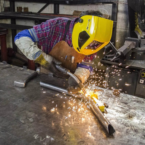 Magswitch Pivot Angle 200 welding magnet in use by welder with yellow helmet, sparks flying