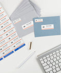 Super Smooth Mailing White Address Labels With Sure Feed Tech Easy Peel Bulk Shipping Stickers For Home Office And Small Biz Laser Inkjet Compatible Hassle Free Printing Guaranteed No Sweat Organization Rock Solid Choice arranged with envelopes and a keyboard.