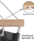 Close-up of cozy double hammock with sturdy wooden stand for outdoors, featuring a hardwood spreader bar with countersunk holes.