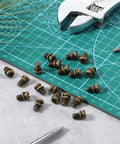 Twenty Pack Ceiling Fan Blade Screws 1/4-20 X 3/8 Phillips Pan Head Heavy Duty Carbon Steel Replacement Fasteners on green cutting mat.