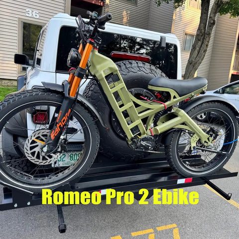 Heavy Duty Full Suspension Electric Bike With Four Thousand Watts Dual Motors And Massive Fifty Two Volt Battery parked on a bike rack.