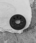 32P 0.8 Mod 57T Carbon Steel Spur Gear For Arrma 1/10 3S RC Cars on a textured surface