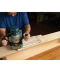 Woodworker using Top Shelf Cleaver Style Cutting Board Router Template with router on hardwood.